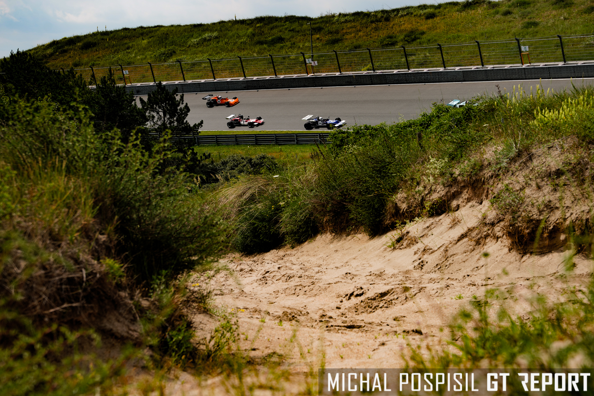 Classic F2 and F3 cars going through Arie Luyendyk banking